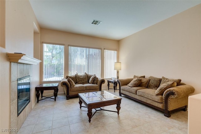 tiled living room featuring a tile fireplace