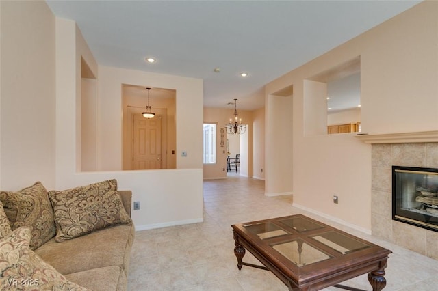 living room featuring a tiled fireplace