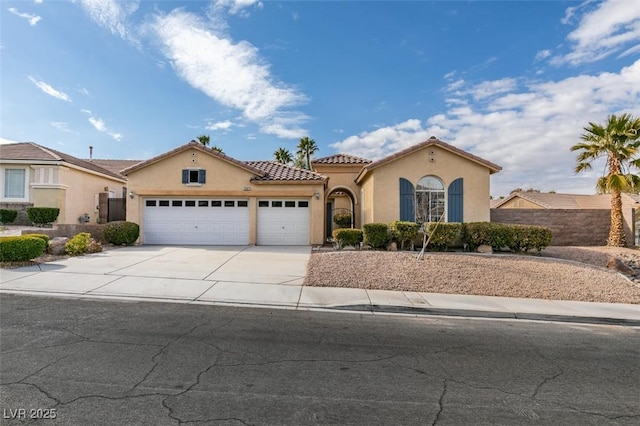 mediterranean / spanish-style home with a garage