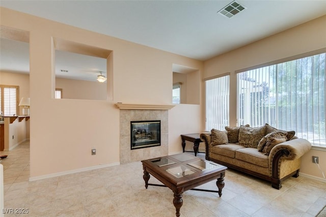 living room featuring light tile patterned floors and a fireplace