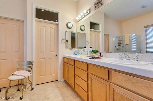 bathroom with vanity, tile patterned floors, and a shower with shower door