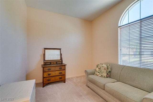 interior space featuring vaulted ceiling and light carpet