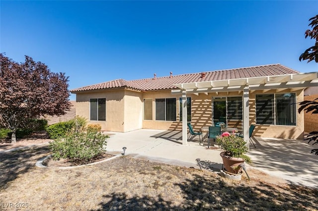 rear view of house with a pergola and a patio