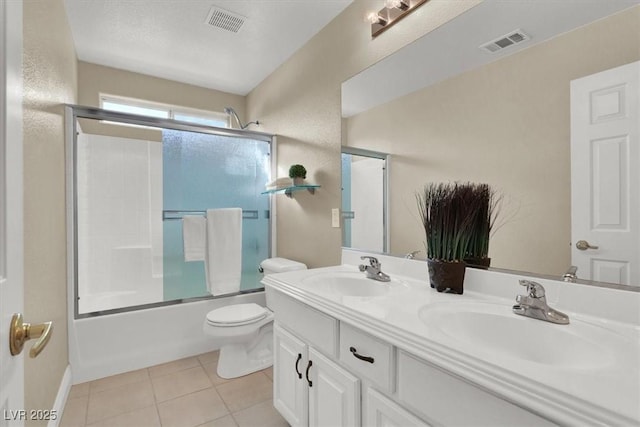 full bathroom with enclosed tub / shower combo, vanity, toilet, and tile patterned flooring