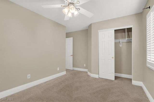 unfurnished bedroom with ceiling fan, a closet, and light carpet