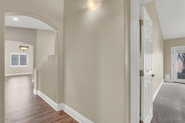 hallway with hardwood / wood-style flooring