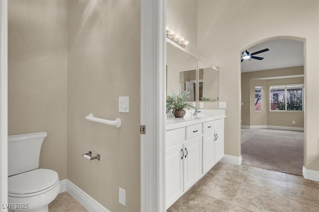 bathroom with vanity, tile patterned floors, toilet, and ceiling fan