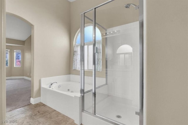 bathroom featuring independent shower and bath and tile patterned flooring