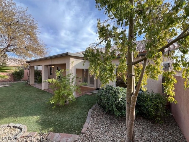 back of property with a patio and a lawn