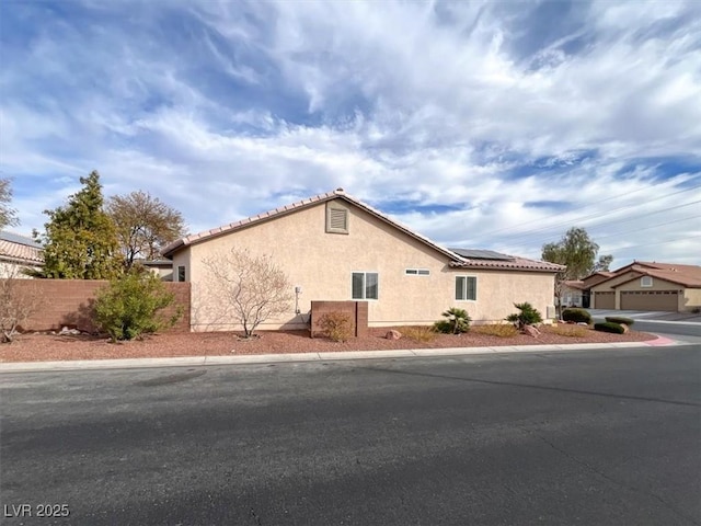 view of property exterior featuring solar panels