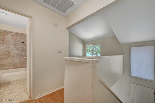 hallway with light hardwood / wood-style flooring