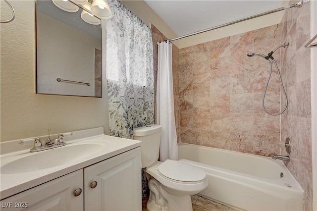 full bathroom with vanity, shower / tub combo with curtain, and toilet