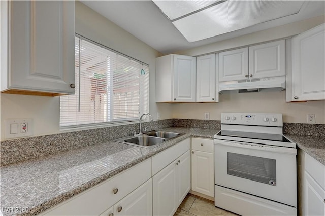 kitchen with electric stove, sink, white cabinets, and light tile patterned flooring