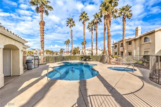 view of swimming pool featuring an in ground hot tub and a patio area