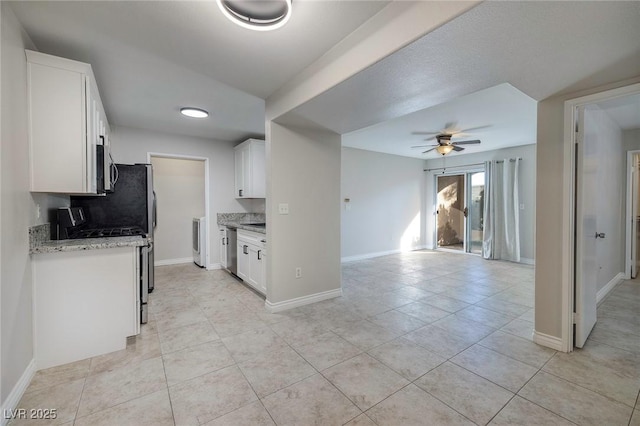 kitchen with ceiling fan, appliances with stainless steel finishes, light tile patterned floors, and white cabinets