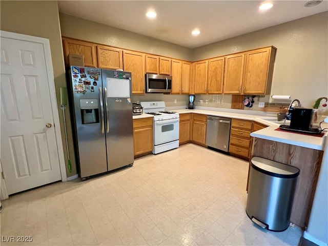 kitchen with sink and appliances with stainless steel finishes