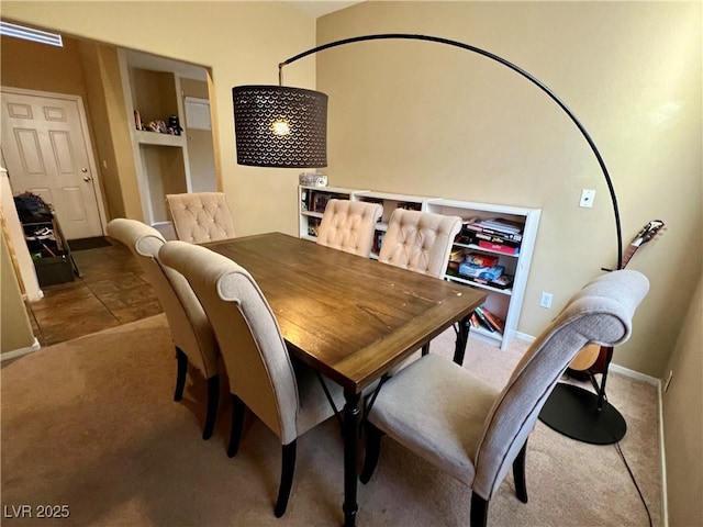 dining space featuring light colored carpet