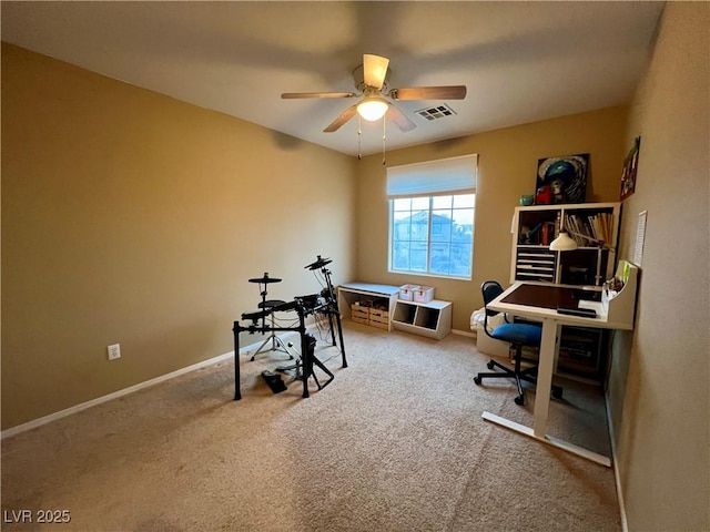 carpeted office space featuring ceiling fan