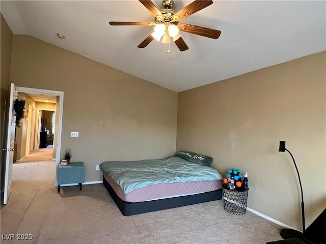 bedroom with ceiling fan, vaulted ceiling, and light carpet