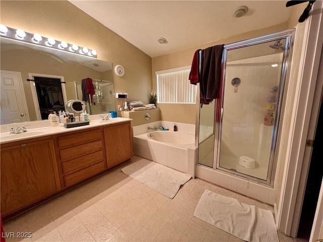 bathroom with vanity, lofted ceiling, and separate shower and tub