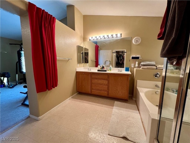 bathroom with vanity, vaulted ceiling, and independent shower and bath