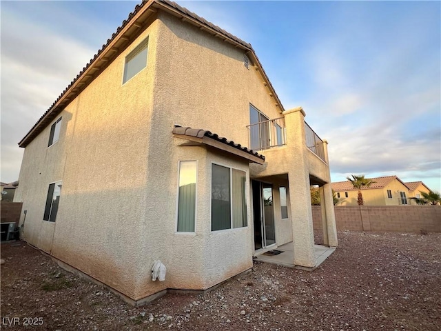 back of property featuring a balcony