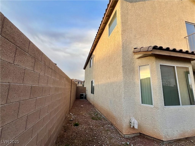 view of side of home featuring central air condition unit