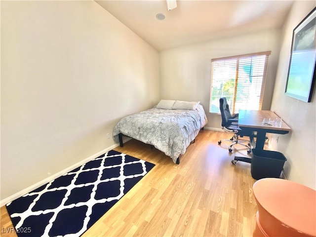 bedroom with lofted ceiling and hardwood / wood-style floors