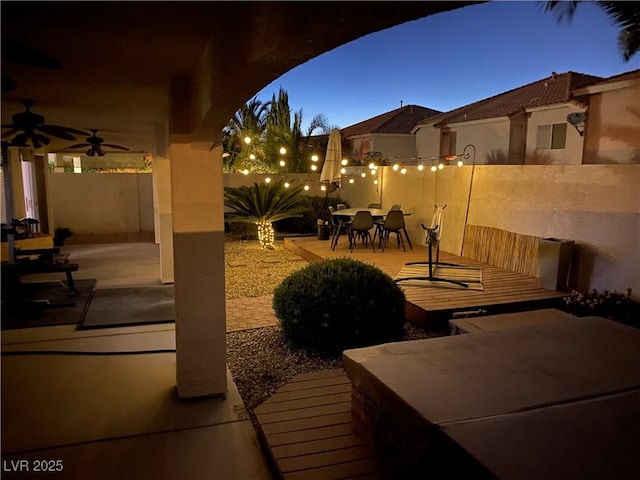 patio terrace at dusk with ceiling fan