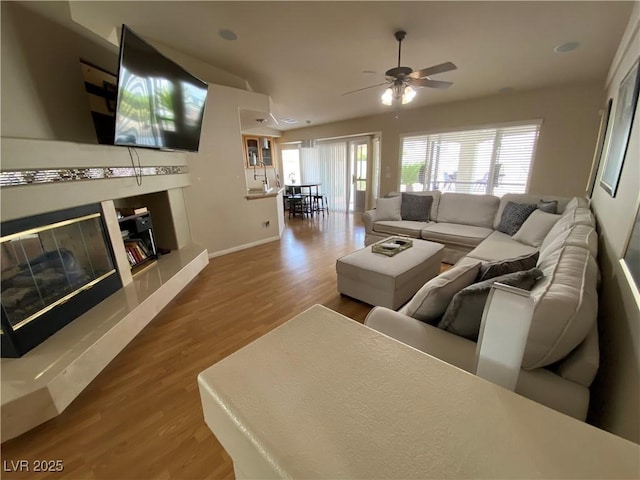 living room featuring hardwood / wood-style floors and ceiling fan