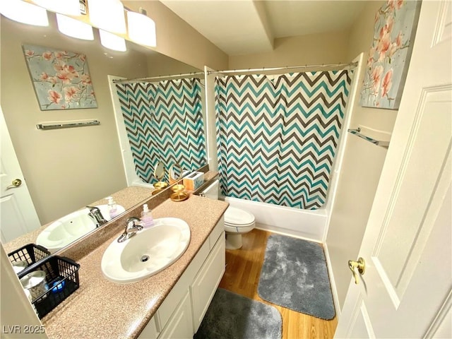 full bathroom featuring hardwood / wood-style flooring, vanity, shower / tub combo with curtain, and toilet