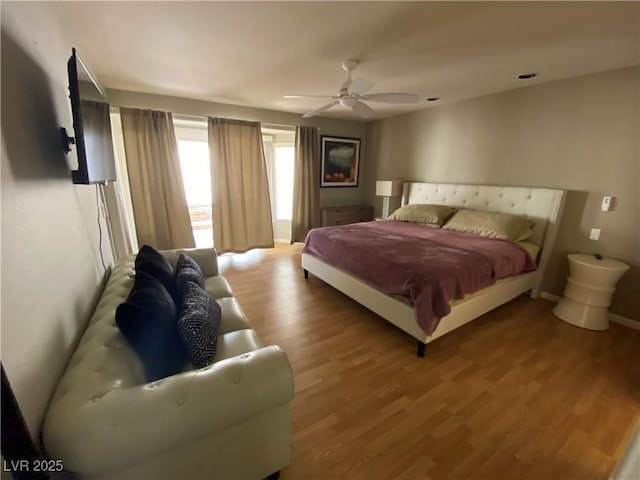 bedroom featuring hardwood / wood-style flooring and ceiling fan