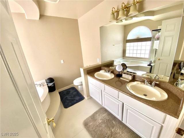 bathroom with toilet, tile patterned floors, vanity, and a bath