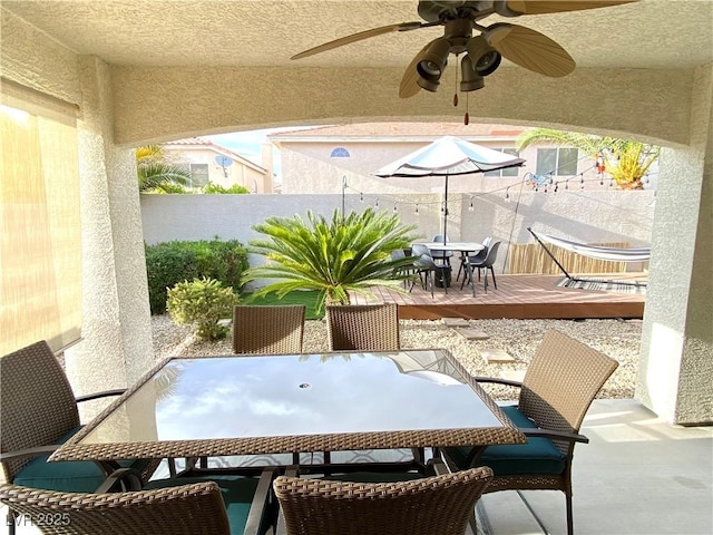 view of patio with ceiling fan and a deck