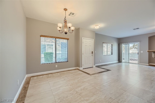 interior space featuring a wealth of natural light and an inviting chandelier