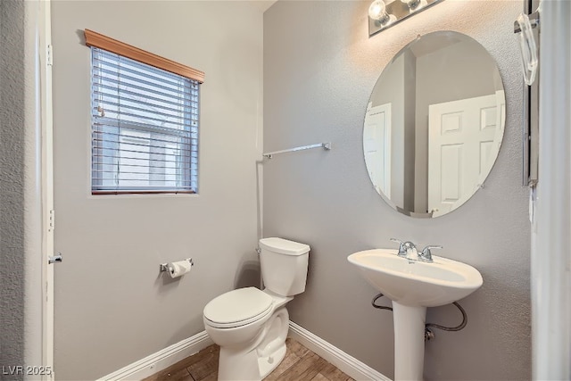 bathroom featuring sink, hardwood / wood-style floors, and toilet