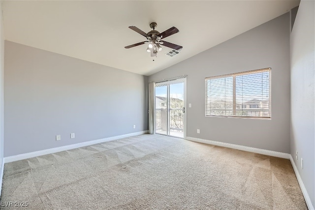 carpeted spare room featuring ceiling fan and lofted ceiling