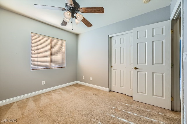 unfurnished bedroom with light colored carpet, ceiling fan, and a closet