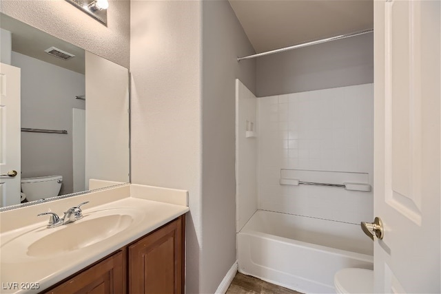 full bathroom featuring vanity,  shower combination, and toilet