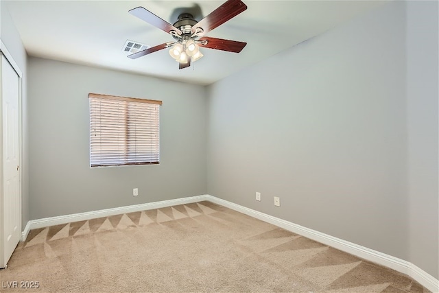 empty room featuring ceiling fan and carpet floors