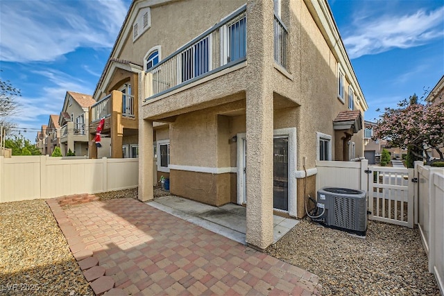 exterior space with cooling unit and a balcony