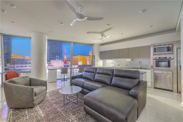 living room with expansive windows, light tile patterned floors, and ceiling fan