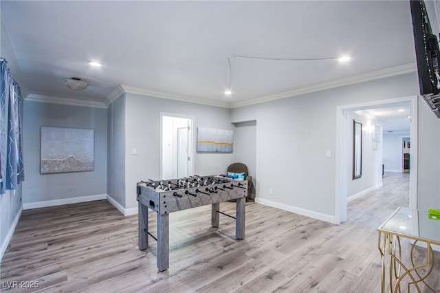 game room featuring crown molding and light wood-type flooring