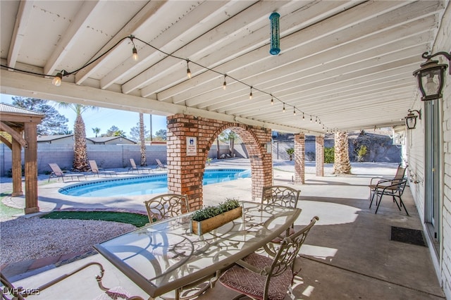 view of patio / terrace with a fenced in pool