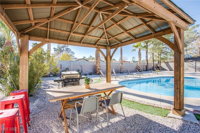 view of patio / terrace with a fenced in pool, a gazebo, and a grill