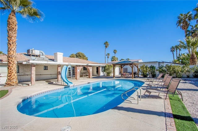 view of pool with a gazebo, a water slide, and a patio