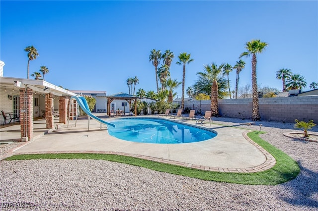 view of swimming pool with a gazebo, a patio area, and a water slide