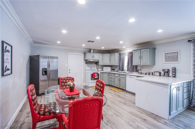 kitchen featuring sink, gray cabinetry, light wood-type flooring, ornamental molding, and white appliances