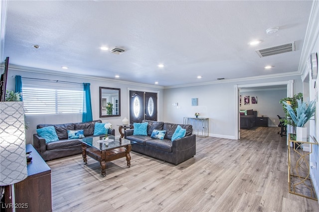 living room featuring crown molding and light hardwood / wood-style floors