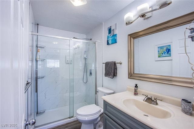 bathroom with walk in shower, vanity, toilet, and a textured ceiling